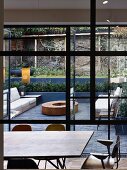 View from dining area onto terrace with vintage brick garden wall in background