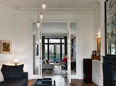 Eclectic, elegant living room in period apartment with stucco ceiling