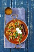 Pork curry with tomatoes, mango, peas and green beans