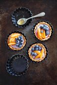 Tartlets with berry mascarpone, blueberries and apricots