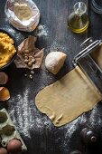 Raw pasta dough in a pasta machine with ingredients