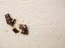 Dark chocolate and crispy cereals on a white tablecloth
