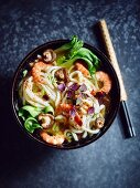 Udon noodles soup with prawns, shiitake mushrooms, bok choy, spring onions, red cress and chilli powder (Asia)