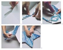 Make decorative stars out of cardboard and blue mottled wool