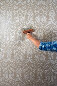 Pasting up patterned wallpaper using a wallpaper brush