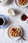 Cornflour and spelt waffles with raspberry jam served with coffee