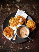 Vegetable cakes made from parsnip and pumpkin spirals with a dip