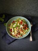 Spicy courgette and parsnip spaghetti with tomatoes and Parmesan cheese