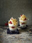 Layered desserts with apple spirals and raspberries