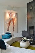 Fireplace, metal chimney breast and modern artwork in lounge area