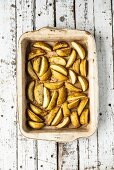 Potato wedges in a roasting dish