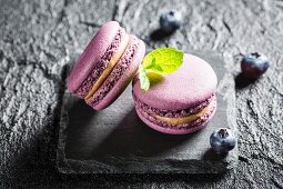 Blueberry macaroons on a black stone