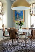 Classic chairs with animal-skin covers around round dining table in corner