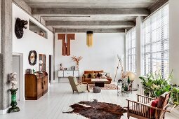 Ribbed concrete ceiling and eclectic furnishings in spacious living area of loft apartment