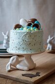 A sprinkled vanilla cake with filled with marshmallows and easter eggs