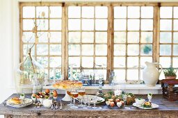 An Easter buffet laid on a wooden table by a window