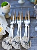 Silver cutlery with name tags on Easter buffet table
