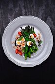 Green asparagus with quail's eggs, shrimps, tomatoes and balsamic cream