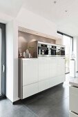 A made-to-measure kitchen cupboard with built in devices in a framed alcove