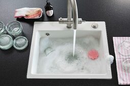 A kitchen island with water flowing into a built-in sink