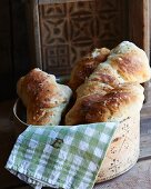 Three focaccia with caraway seeds in a bread basket