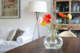 Poppies in glass vase