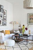 White loose-covered sofas and delicate coffee table in comfortable living room