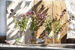 Marjoram flowers and astrantia in sugar shakers with labels