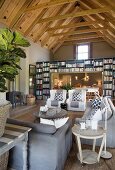 Exposed roof structure and bookcase in living room