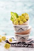 Romanesco broccoli florets in a stack of bowls