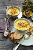 Creamy carrot soup topped with carrot and fennel
