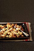 Croutons with garlic and herbs on a baking tray