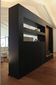 Black partition wall with shelves and apertures