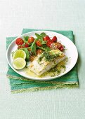 Fried fish fillet with chilli and herb oil and a tomato and bean salad