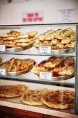 Arabic pastries and unleavened bread in a display case