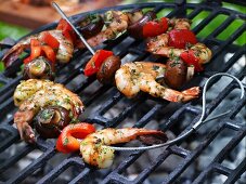 Scampi and vegetable kebabs on a grill with a garlic marinade