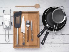 Kitchen utensils: pounds, a sieve, the greater, a spatula and kitchen knives
