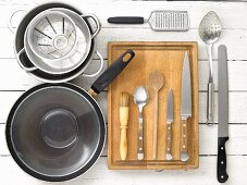 Kitchen utensils: a pan, pots, a grater, a draining spoon and knives