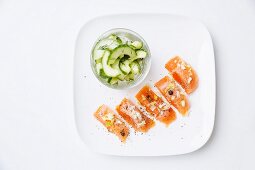 Marinated salmon trout with a cucumber salad and juniper berries