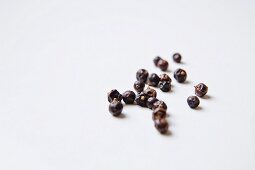 Juniper berries on a white surface