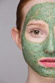 A young woman with a green face mask