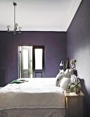 White bed and black walls in bedroom