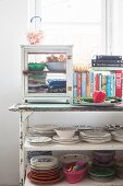 Crockery and small display case on old serving trolley