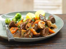 Marinated venison goulash with mushrooms and brussel sprouts