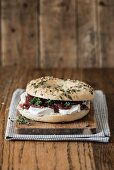 A bagel with cream cheese and red onion chutney