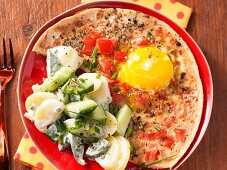 Tomato eggs with a potato and cucumber salad