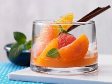 Citrus fruits in spicy syrup with mint