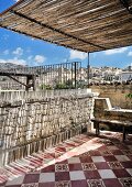 Traditional tiled floor and city view on Mediterranean roof terrace