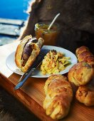 Hot dog buns with grilled wild boar sausage and coleslaw