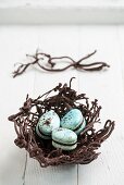 Three blue macarons in an Easter nest